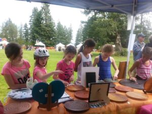 Lisa's booth at the Fair. Children are captivated by the Cedar Labyrinths