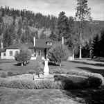 B&W photo of a heritage manor house, garden in foreground